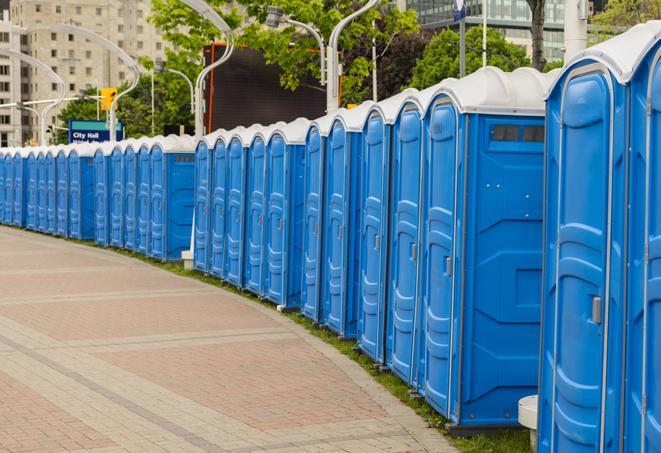 a row of portable restrooms set up for a large athletic event, allowing participants and spectators to easily take care of their needs in Mcclellan CA